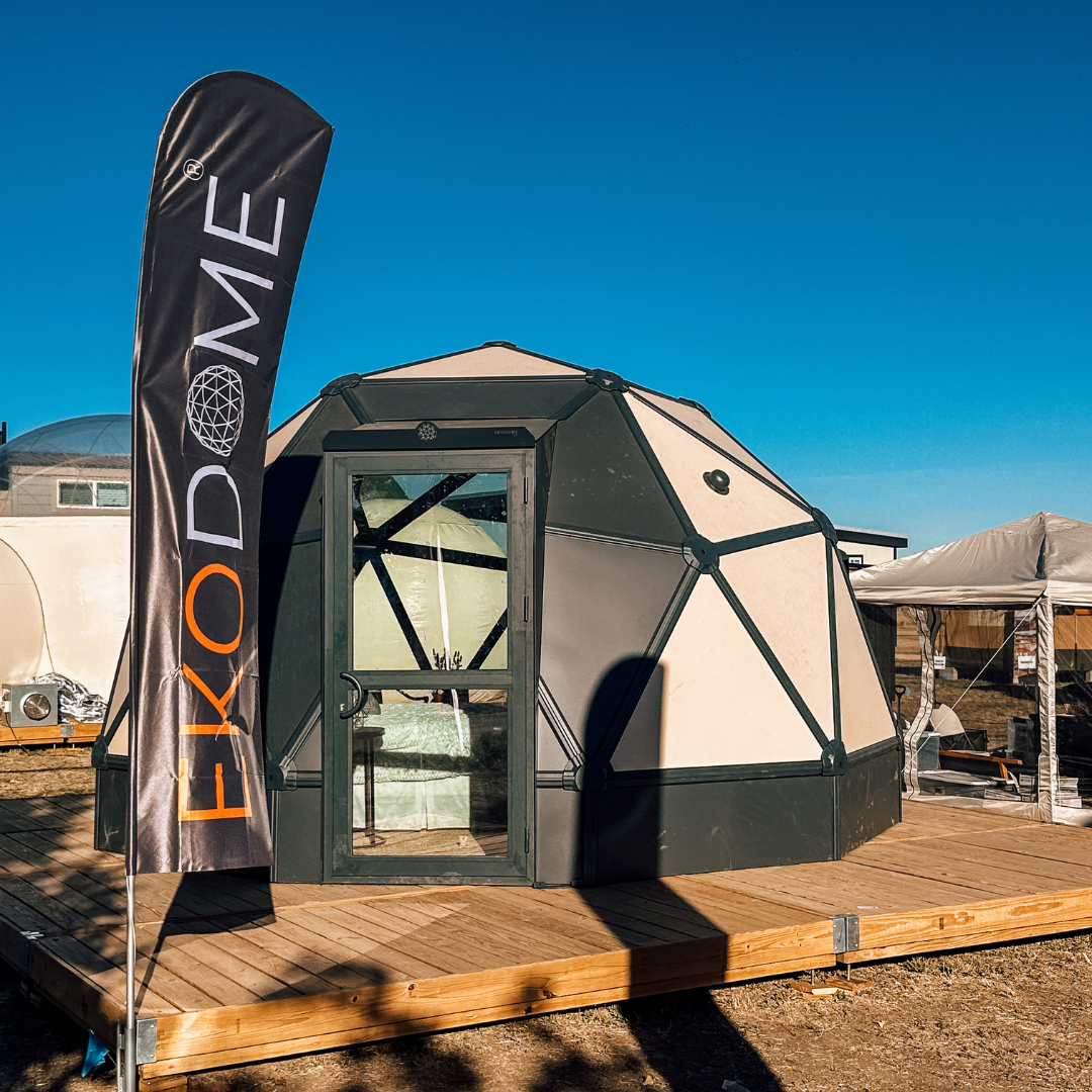 Ekodome hardshell geodesic tent on a Flatspot Decking Services wooden deck at the Glamping Show Americas.