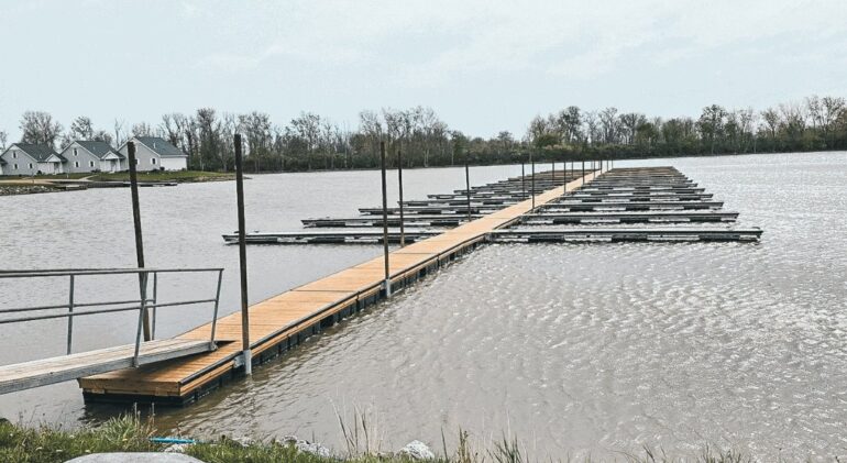 Wooden deck floating on water for use in marinas.