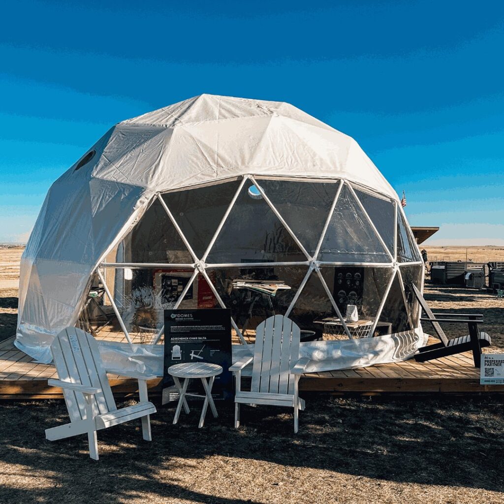 FDomes geodesic tent on a wooden deck by Flatspot Decking Services at the Glamping Show Americas.