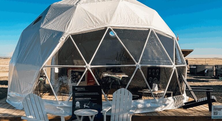 FDomes geodesic tent on a wooden deck by Flatspot Decking Services at the Glamping Show Americas.