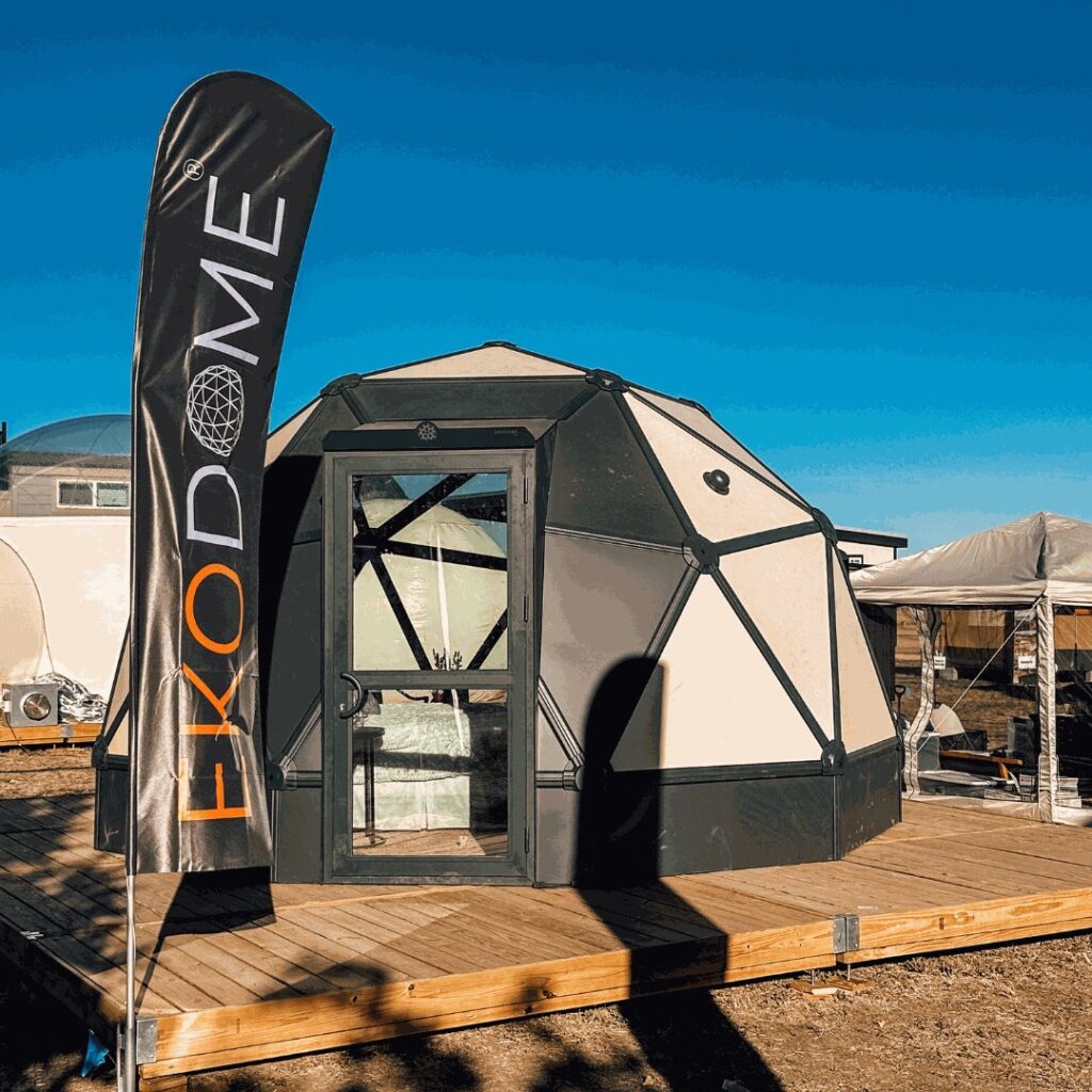 Ekodome hardshell geodesic tent on a Flatspot Decking Services wooden deck at the Glamping Show Americas.