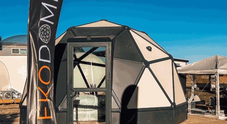 Ekodome hardshell geodesic tent on a Flatspot Decking Services wooden deck at the Glamping Show Americas.